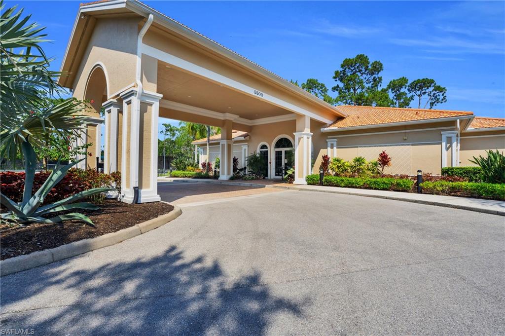 4950 Deerfield Way, Unit 103 Naples, FL 34110 - Photo 29 of 39 a view of a house with a street