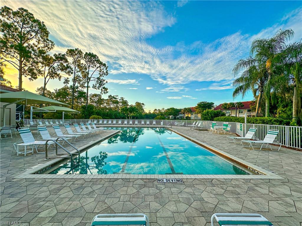 4950 Deerfield Way, Unit 103 Naples, FL 34110 - Photo 31 of 39 a view of a lake with a garden