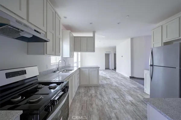 a view of a room with wooden floor