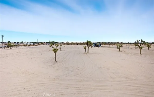 an empty room with closet and windows