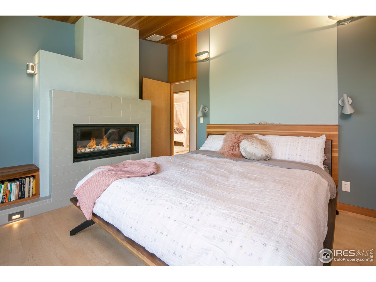 2235 Vassar Drive Boulder, CO 80305 - Photo 21 of 40 a bedroom with a bed and a fireplace