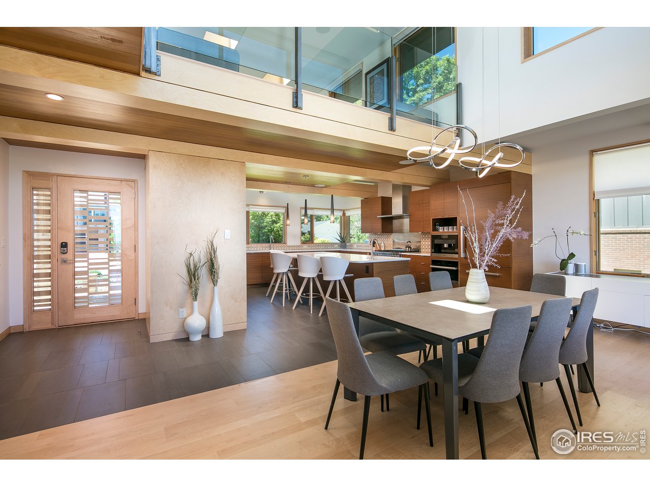 2235 Vassar Drive Boulder, CO 80305 - Photo 4 of 40 a dining room with furniture a floor to ceiling window and wooden floor