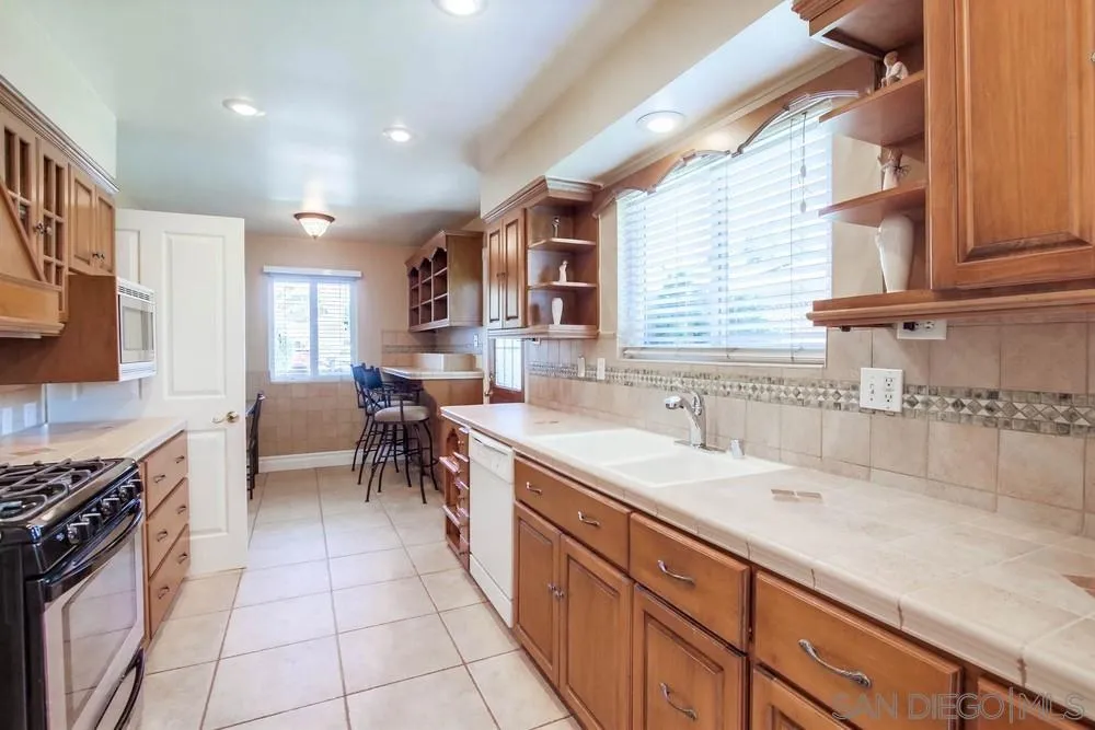 14655 Evening Star Drive Poway, CA 92064 - Photo 16 of 33 a kitchen with a sink and a stove top oven
