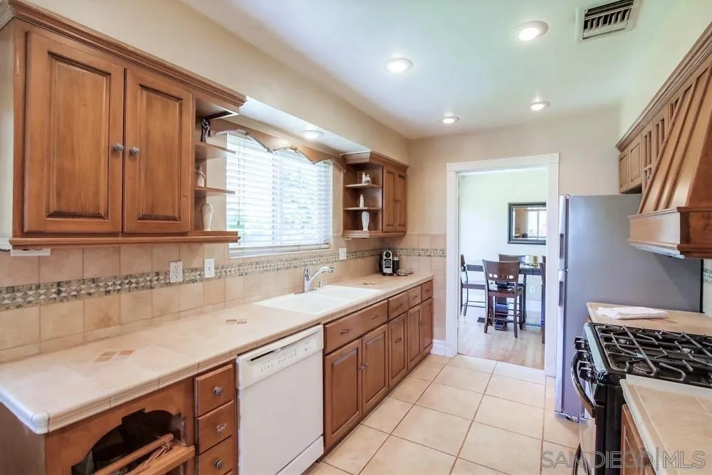 14655 Evening Star Drive Poway, CA 92064 - Photo 18 of 33 a kitchen that has a sink and a stove in it