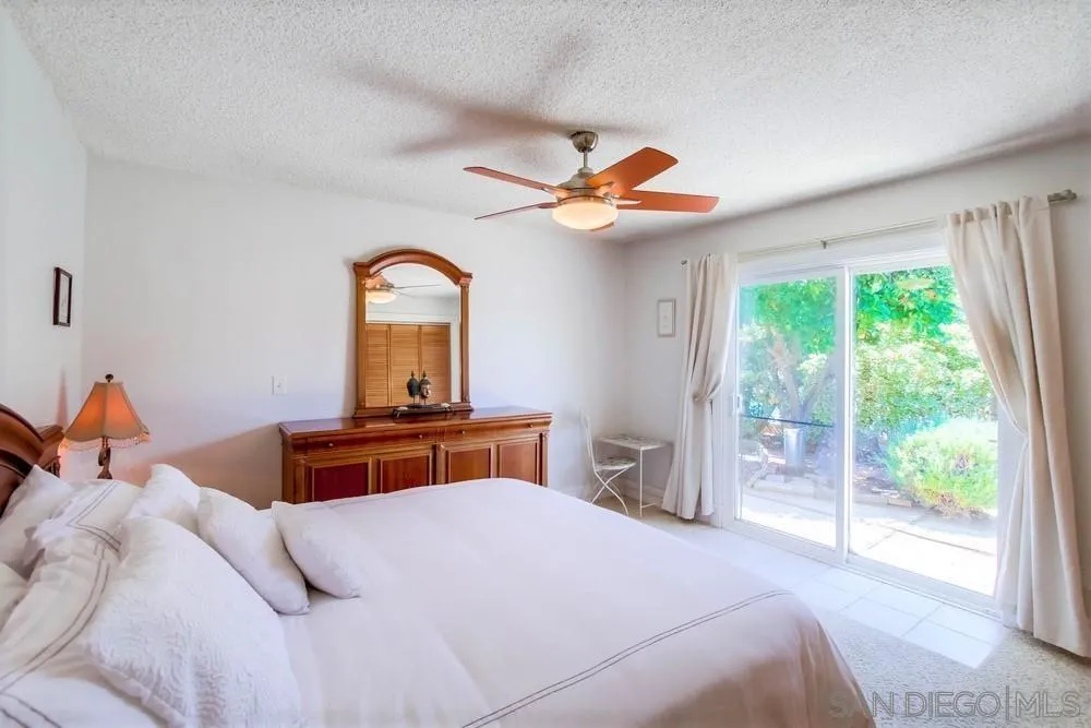 14655 Evening Star Drive Poway, CA 92064 - Photo 20 of 33 a bedroom with a bed and a chandelier