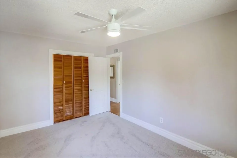 14655 Evening Star Drive Poway, CA 92064 - Photo 29 of 33 an empty room with closet and a ceiling fan