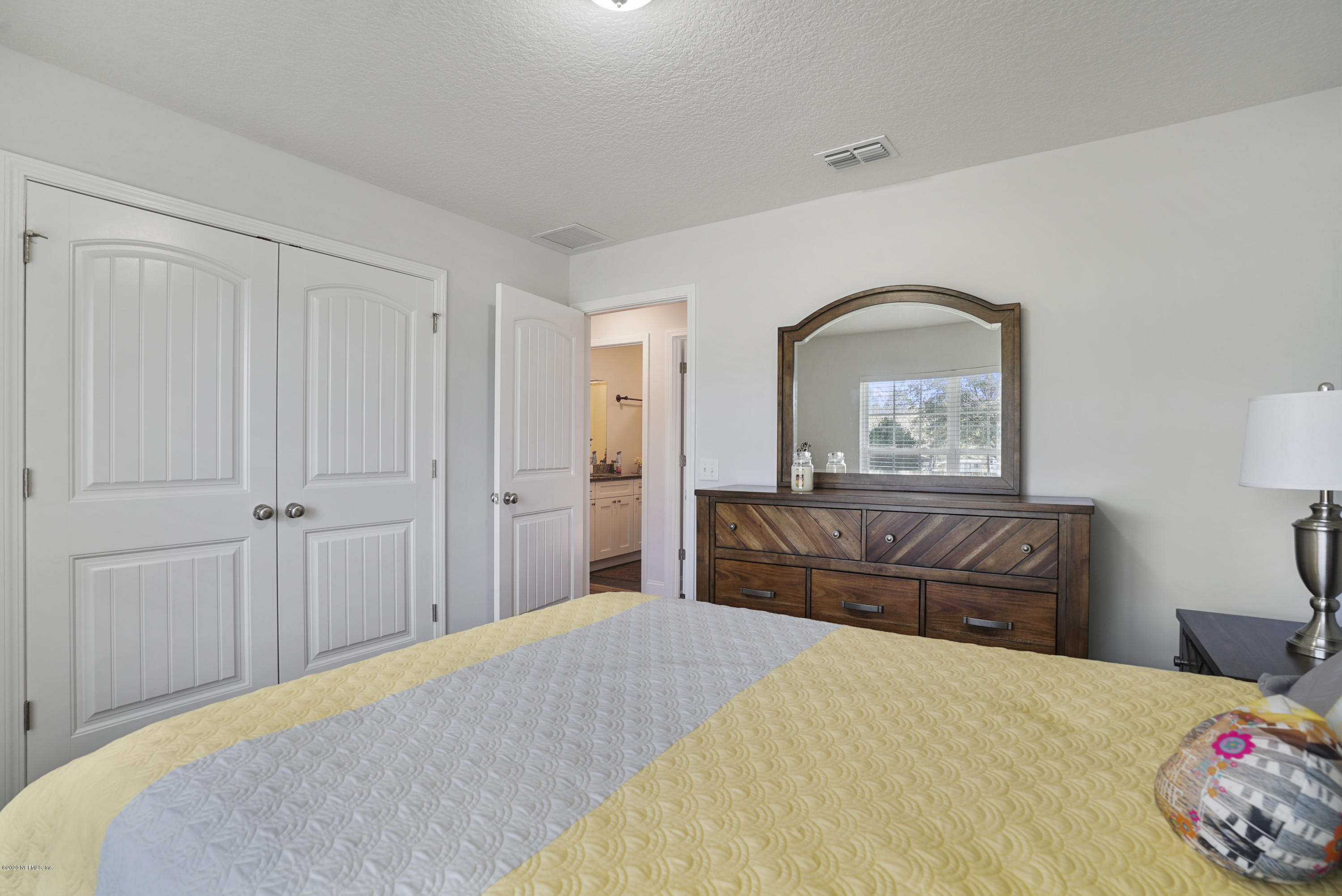 54096 Jeannie Road Callahan, FL 32011 - Photo 15 of 19 a bedroom with a bed and a dresser