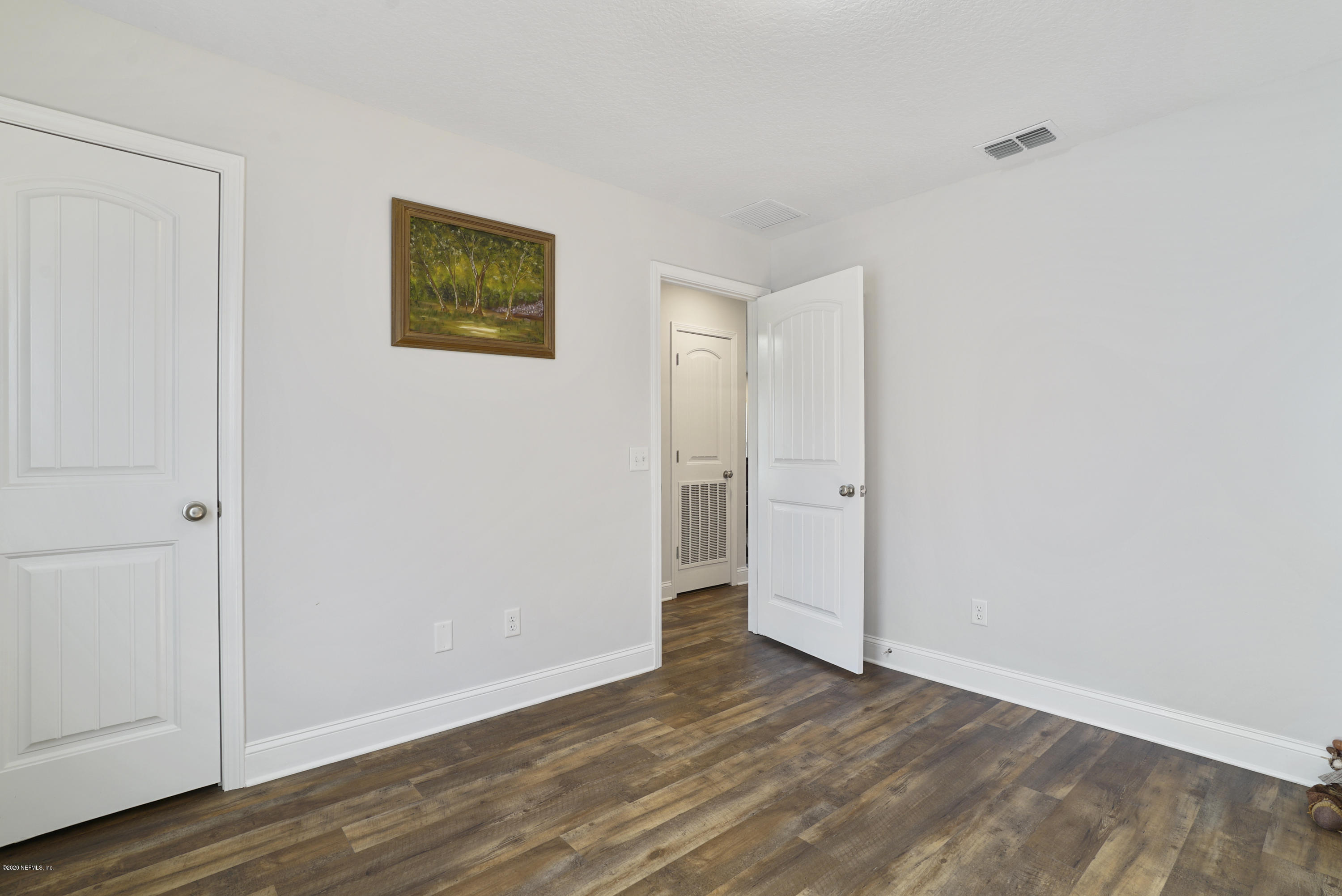 54096 Jeannie Road Callahan, FL 32011 - Photo 17 of 19 a view of a room with wooden floor and closet