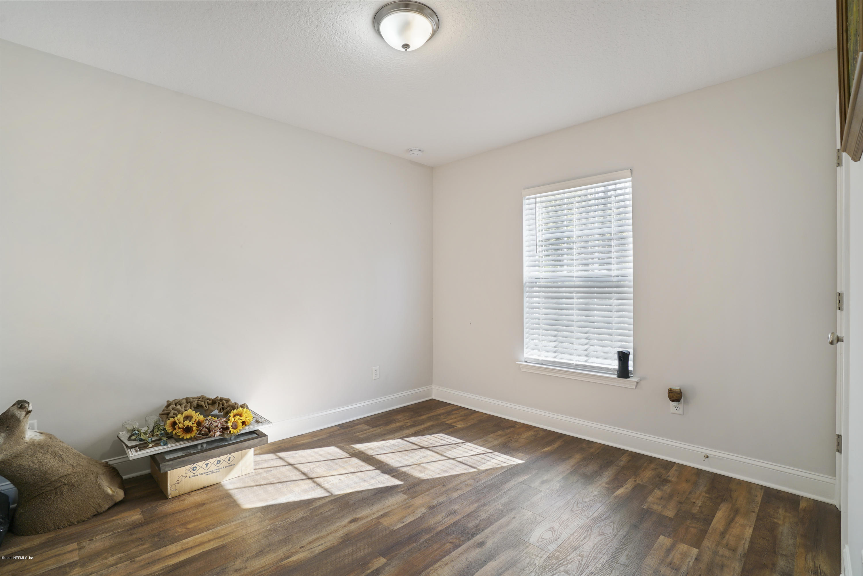 54096 Jeannie Road Callahan, FL 32011 - Photo 18 of 19 a view of an empty room with window and wooden floor