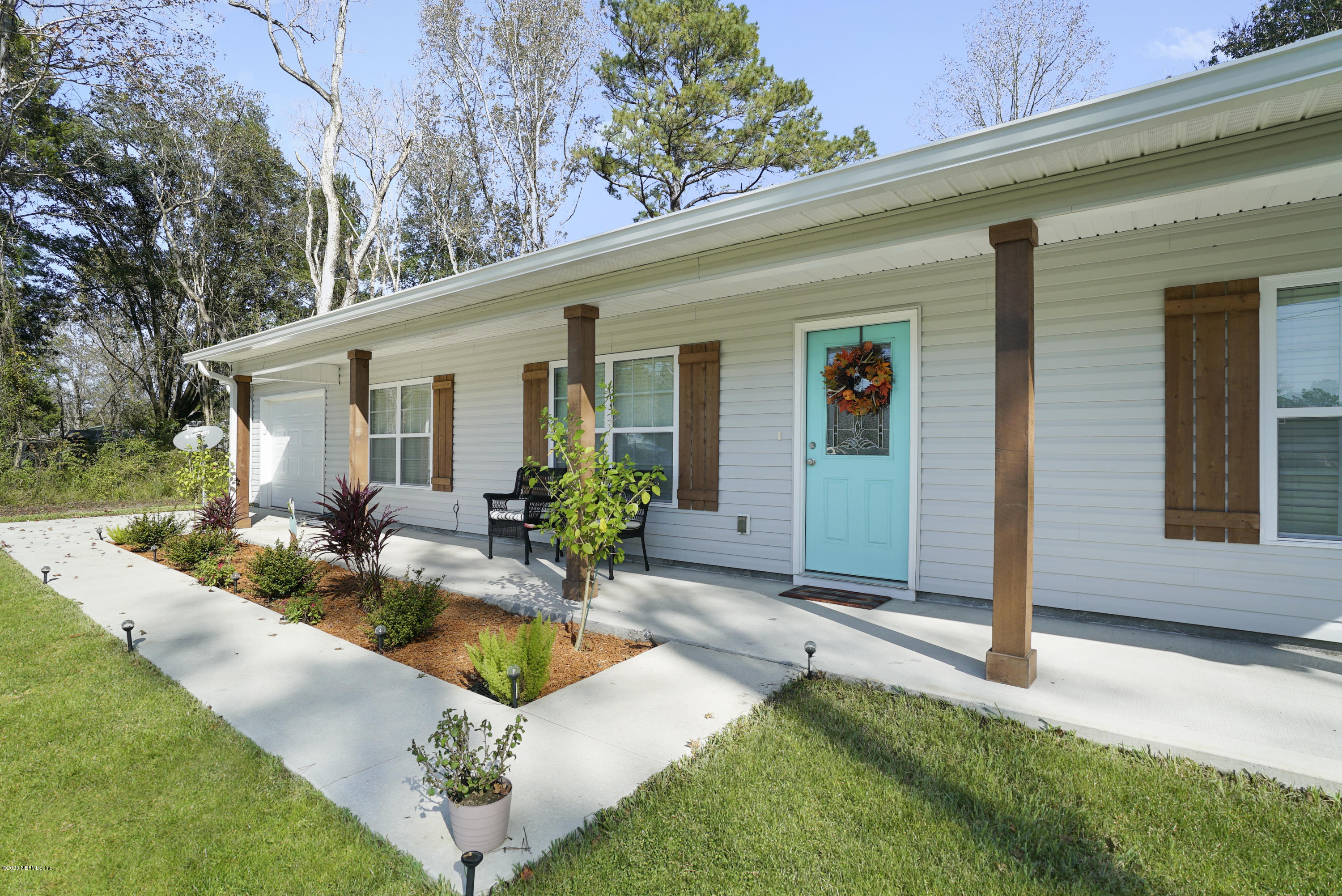 54096 Jeannie Road Callahan, FL 32011 - Photo 3 of 19 a front view of house with yard and outdoor seating