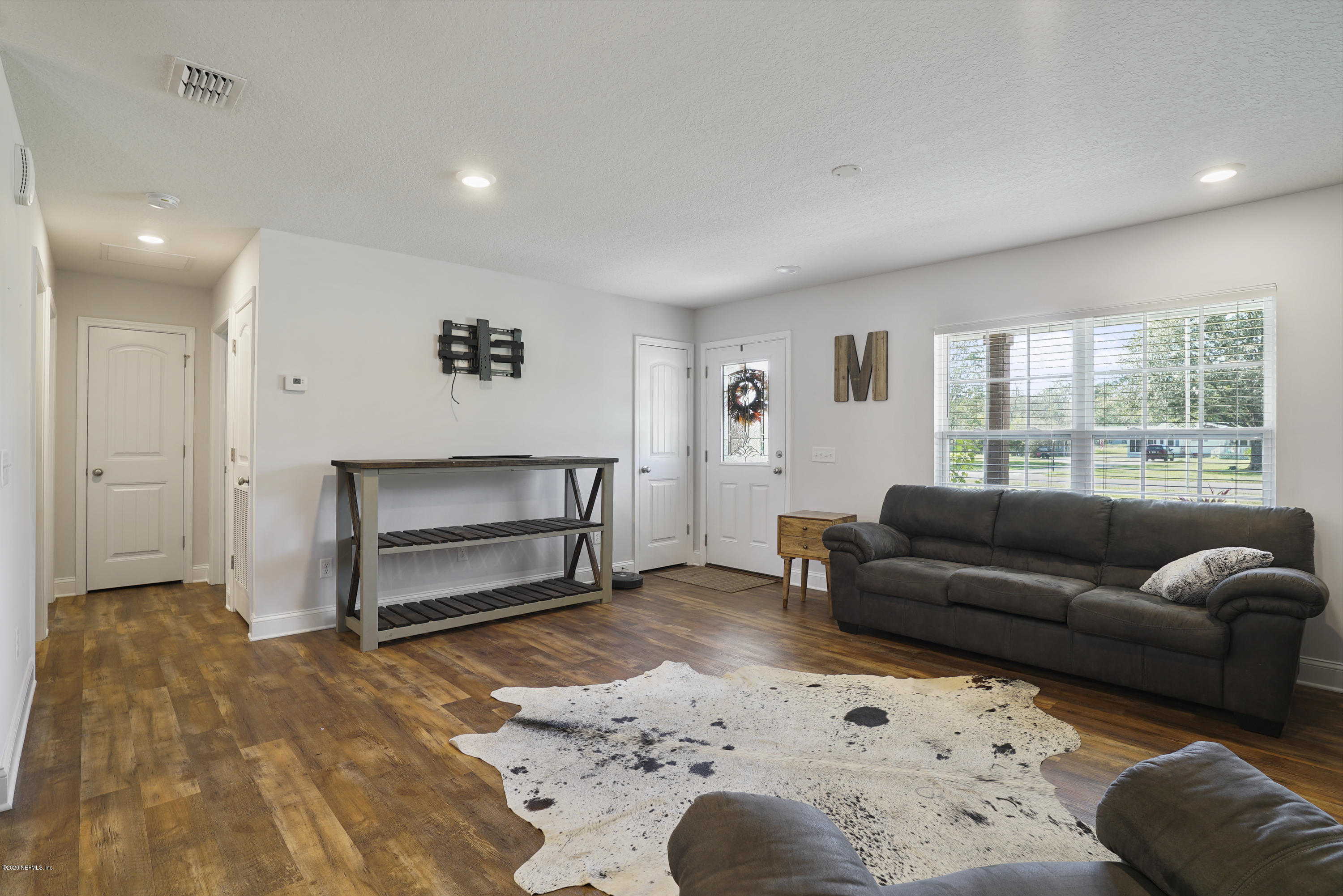 54096 Jeannie Road Callahan, FL 32011 - Photo 5 of 19 a living room with a couch and a window