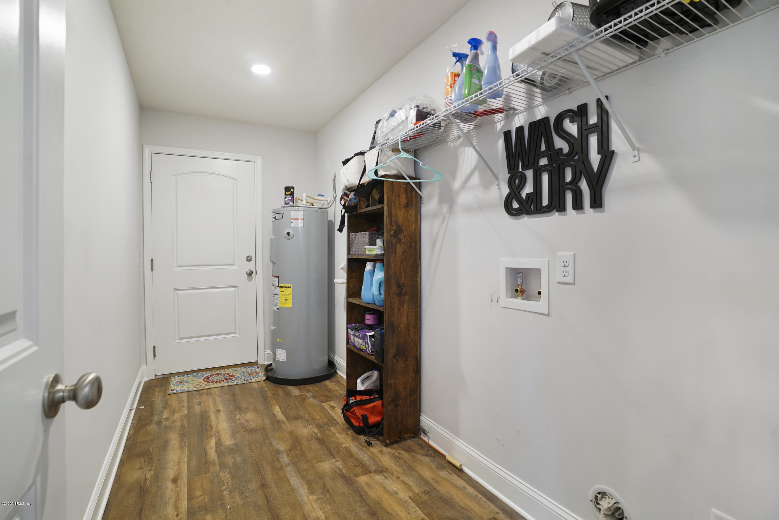 54096 Jeannie Road Callahan, FL 32011 - Photo 10 of 19 a view of walk in closet with clothes and shoes