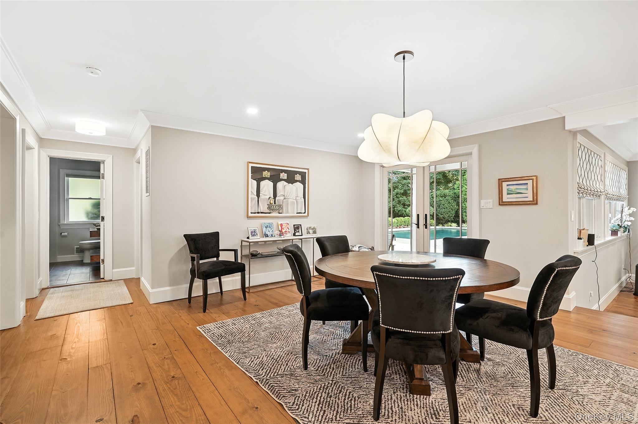 548 Anderson Hill Road Purchase, NY 10577 - Photo 14 of 46 a dining room with furniture a chandelier and wooden floor