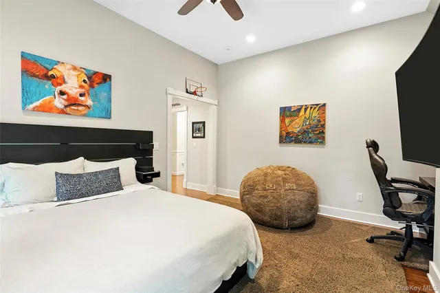 a bedroom with a bed and painting on the wall