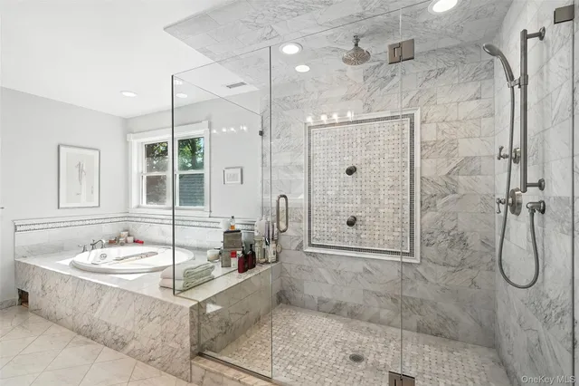 a bathroom with a granite countertop shower a sink and a mirror