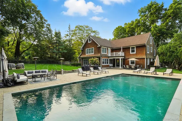 a view of a house with swimming pool and sitting area
