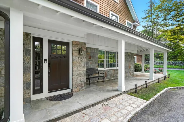 a view of a house with backyard sitting area and porch