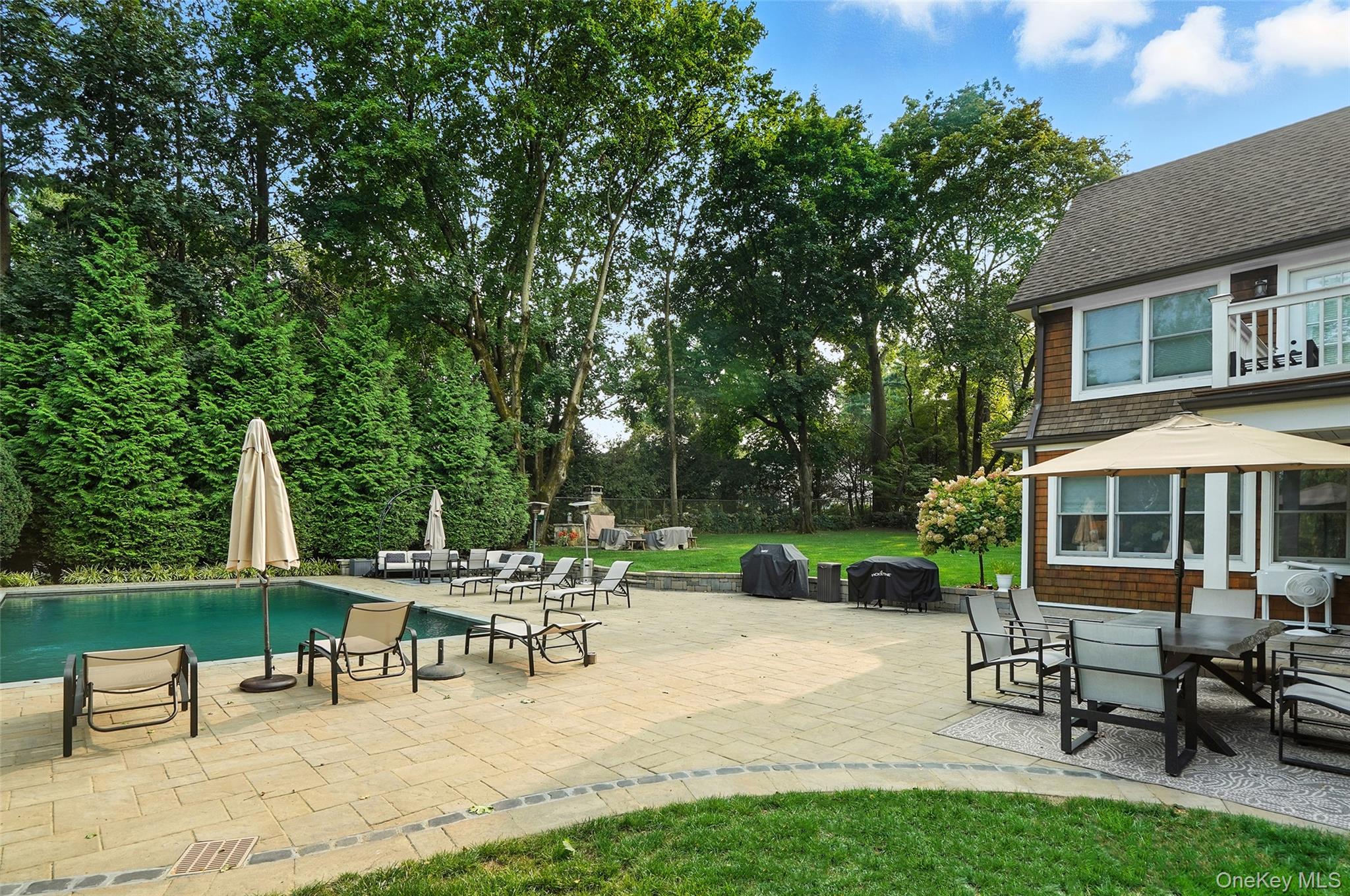 548 Anderson Hill Road Purchase, NY 10577 - Photo 41 of 46 a view of a patio with table and chairs with wooden fence and plants
