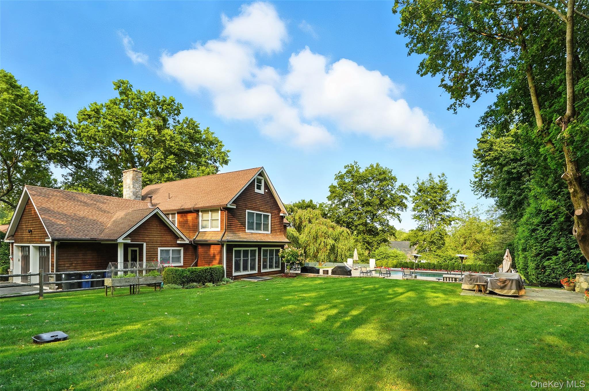 548 Anderson Hill Road Purchase, NY 10577 - Photo 43 of 46 a front view of a house with a garden