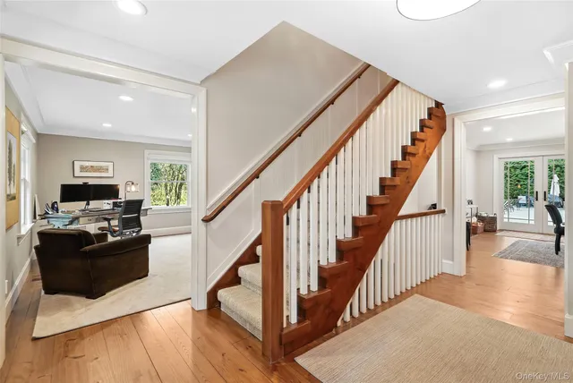a view of entryway and hall with wooden floor