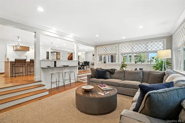 a living room with furniture and view of kitchen