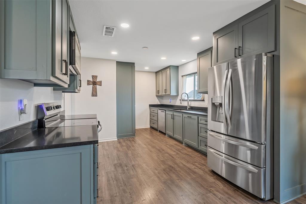300 Rash Lane Terrell, TX 75160 - Photo 5 of 28 a kitchen with stainless steel appliances granite countertop a refrigerator sink and microwave