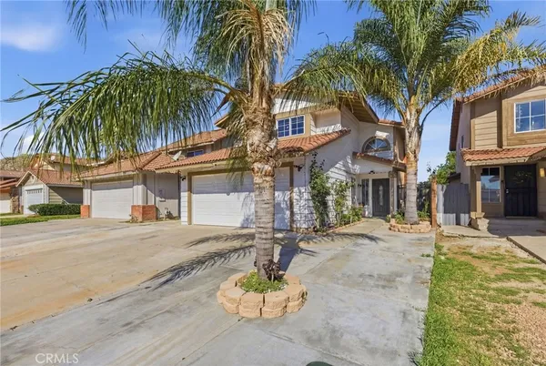 a view of a house with a yard and tree s