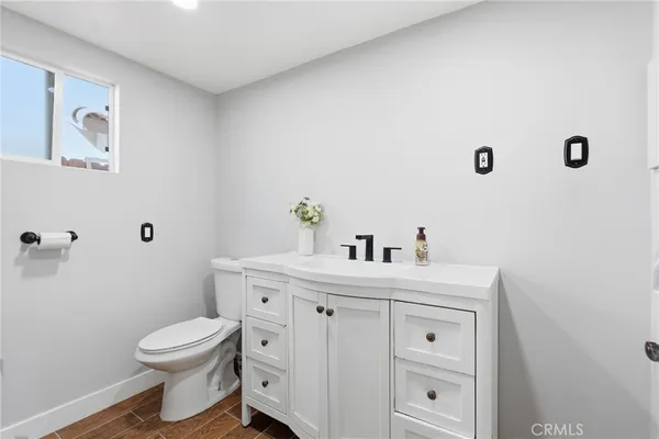 a bathroom with a sink a toilet and a mirror