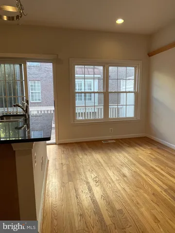 a view of a house with wooden fence and two windows