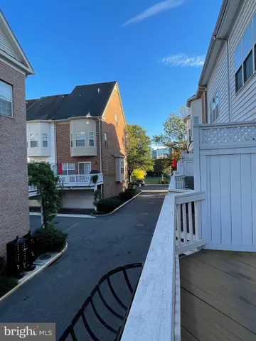 a kitchen with stainless steel appliances granite countertop a refrigerator a stove and a sink with wooden floor