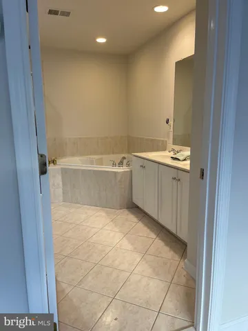 a view of a bathroom with a sink and a mirror