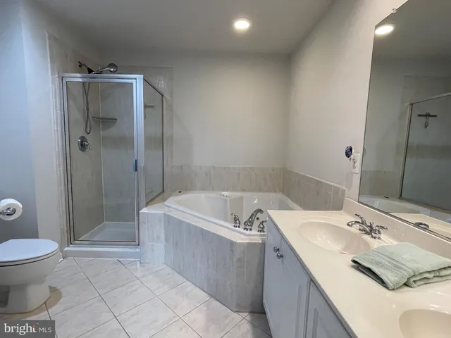 a bathroom with a bathtub sink and mirror