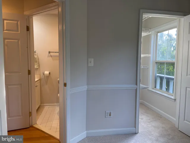 a view of a livingroom with wooden floor and a window