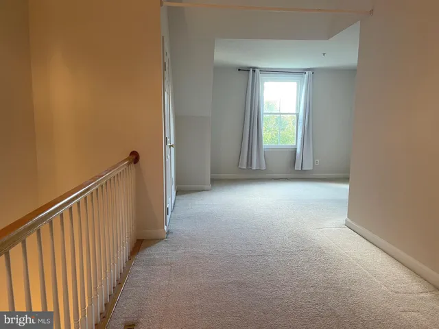 a view of a brick building with a bench in front of building