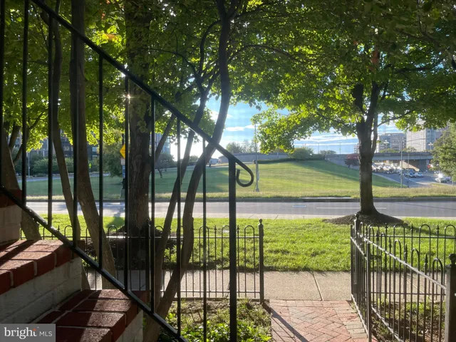 a front view of a house with a tree