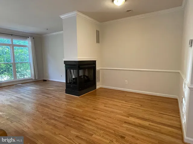 a kitchen with stainless steel appliances granite countertop a stove and a wooden floors
