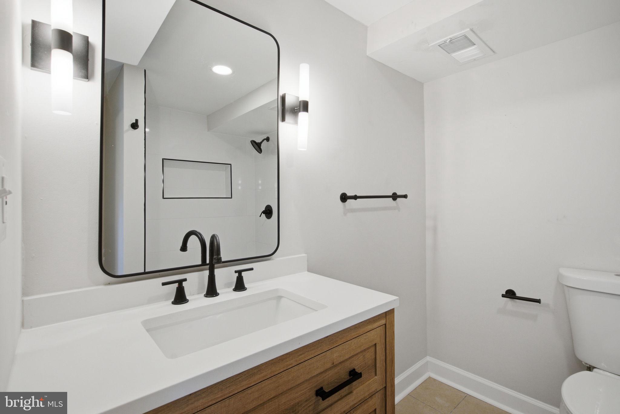 6615 Valley Park Road Capitol Heights, MD 20743 - Photo 24 of 25 Sleek modern bathroom with elegant fixtures.