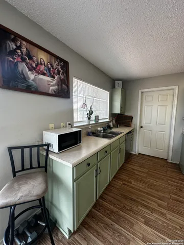 a kitchen with a cabinets and chairs