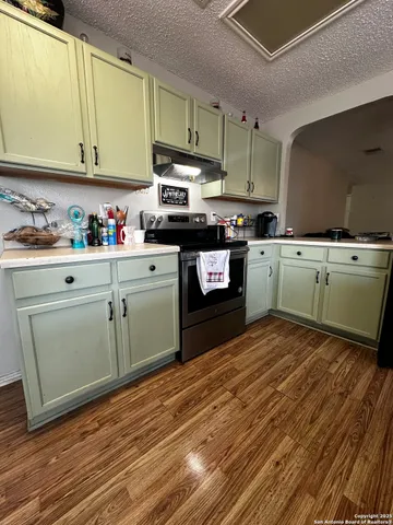 a kitchen with cabinets a sink and appliances