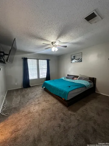 a bedroom with a bed and window