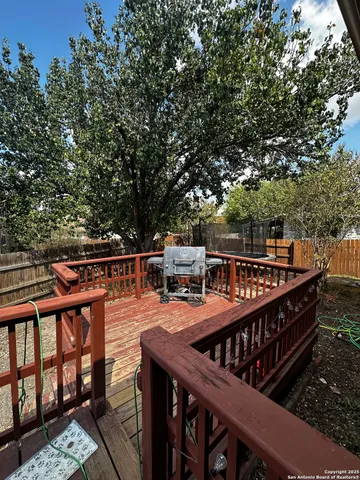 a balcony with wooden floor and outdoor seating