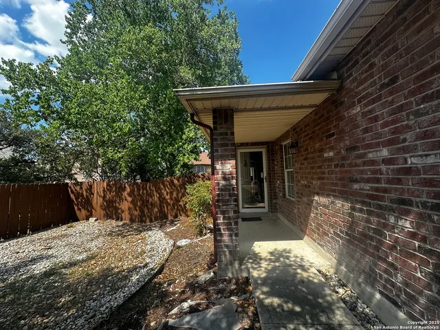 a view of a house with a tree in the background