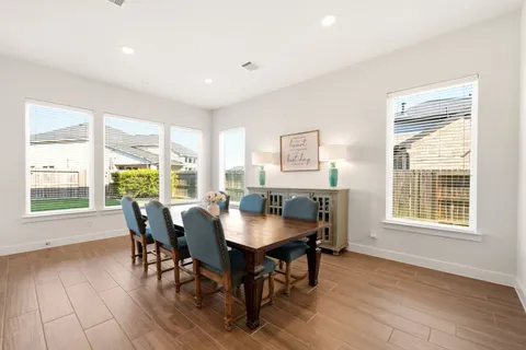 a dining room with furniture window wooden floor