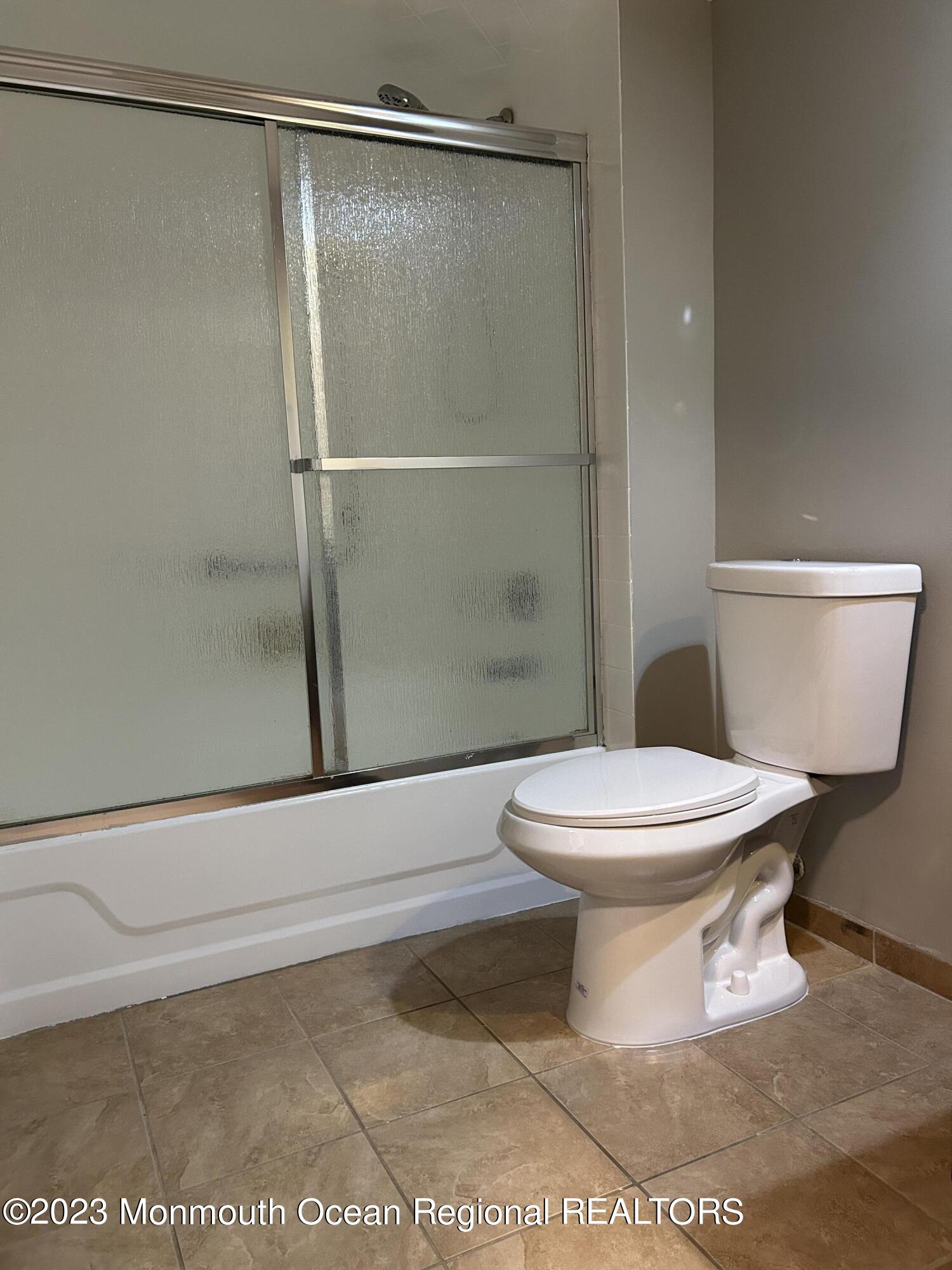 136 Amberly Drive, Unit F Manalapan, NJ 07726 - Photo 11 of 14 a white toilet sitting next to a shower