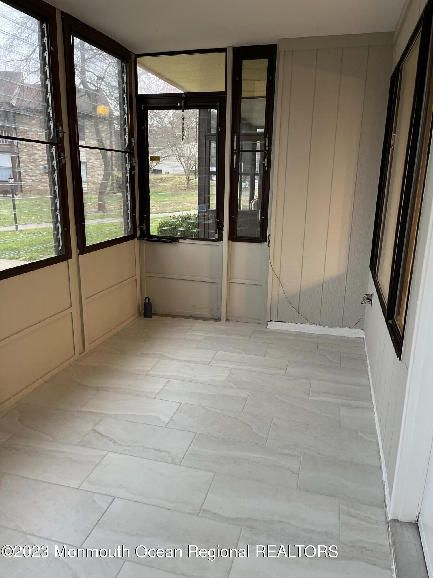 136 Amberly Drive, Unit F Manalapan, NJ 07726 - Photo 2 of 14 a view of an empty room with a large window