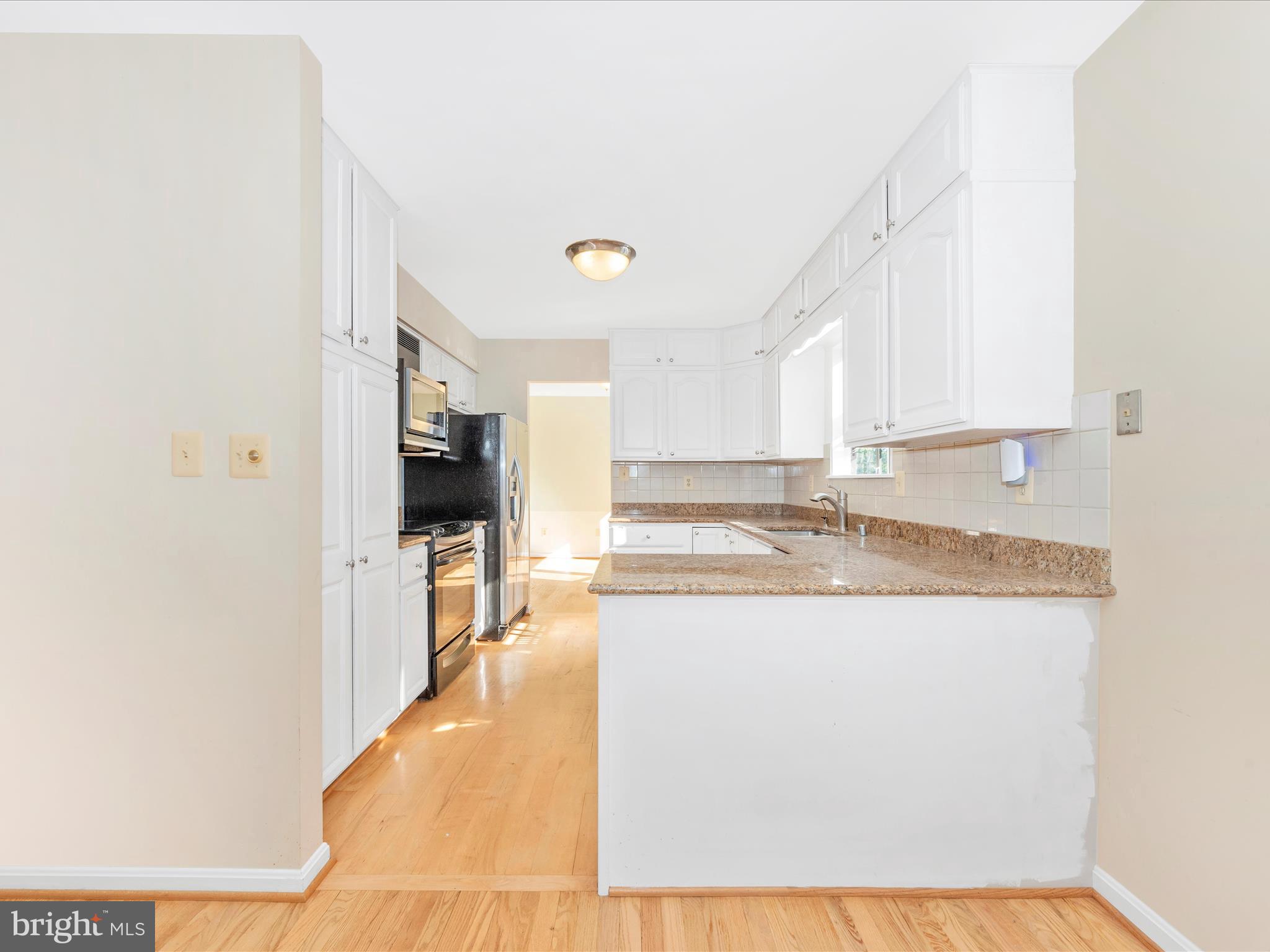 5169 Perry Road Mount Airy, MD 21771 - Photo 11 of 60 a view of a kitchen with kitchen island white cabinets and stainless steel appliances