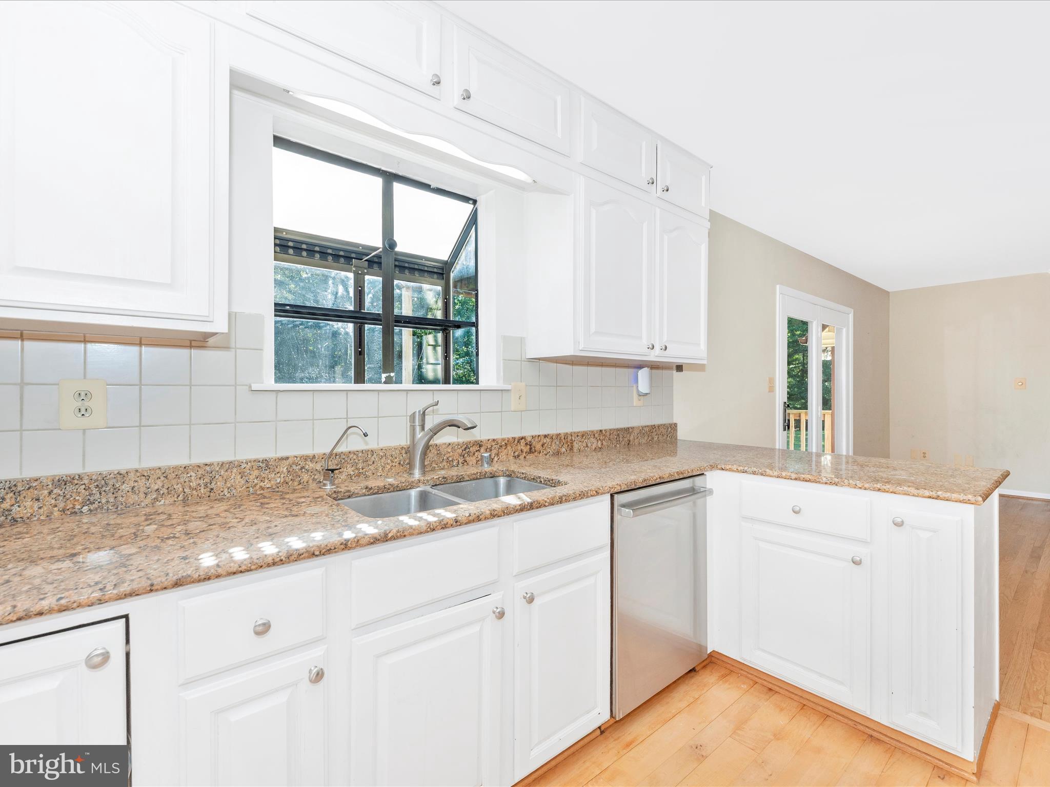 5169 Perry Road Mount Airy, MD 21771 - Photo 19 of 60 a kitchen with granite countertop white cabinets and a window