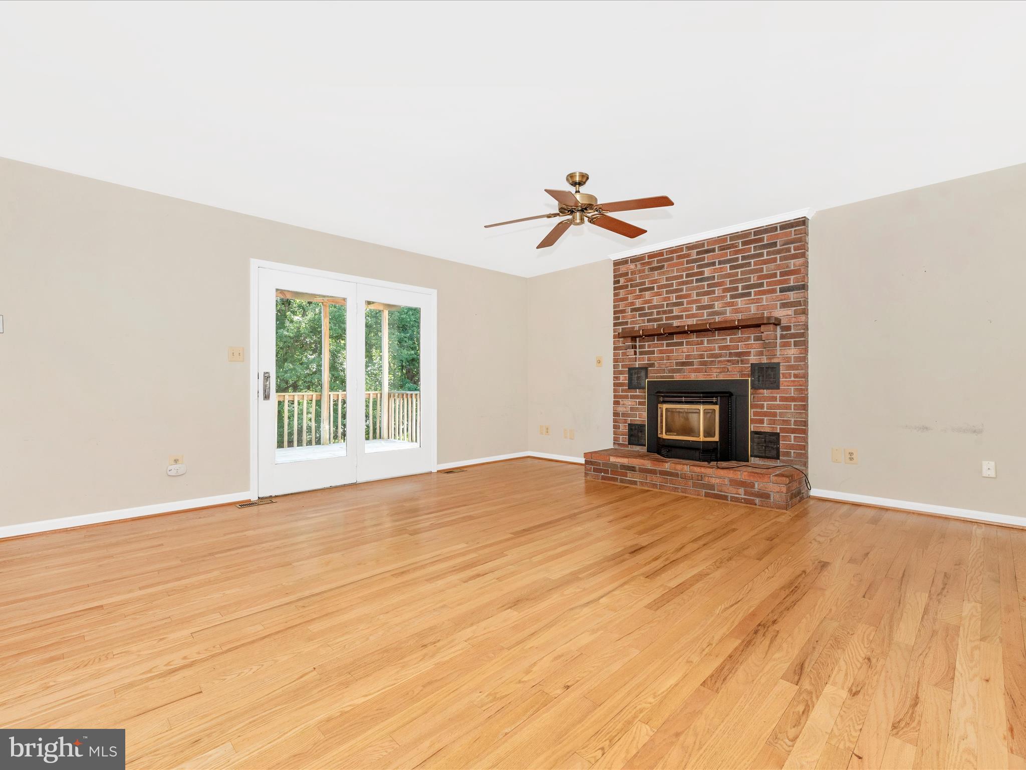 5169 Perry Road Mount Airy, MD 21771 - Photo 20 of 60 an empty room with wooden floor a fireplace