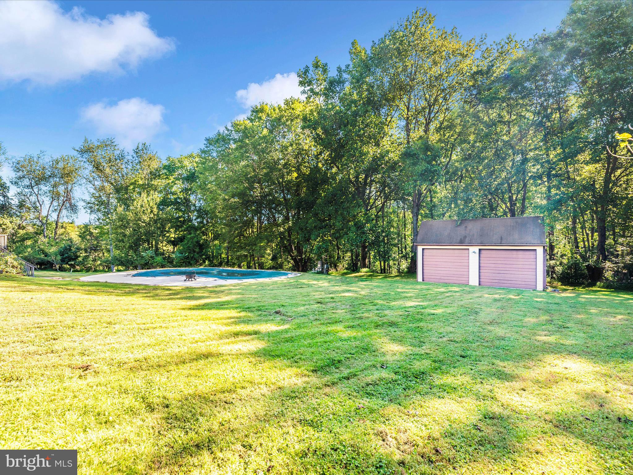 5169 Perry Road Mount Airy, MD 21771 - Photo 45 of 60 a view of yard with swimming pool and trees in the background