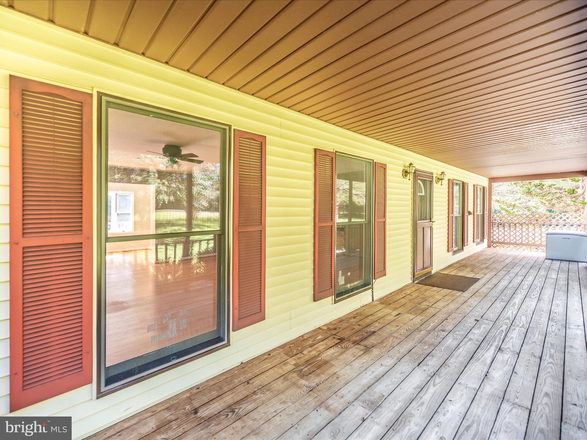 5169 Perry Road Mount Airy, MD 21771 - Photo 53 of 60 a view of a porch with wooden floor and floor to ceiling window